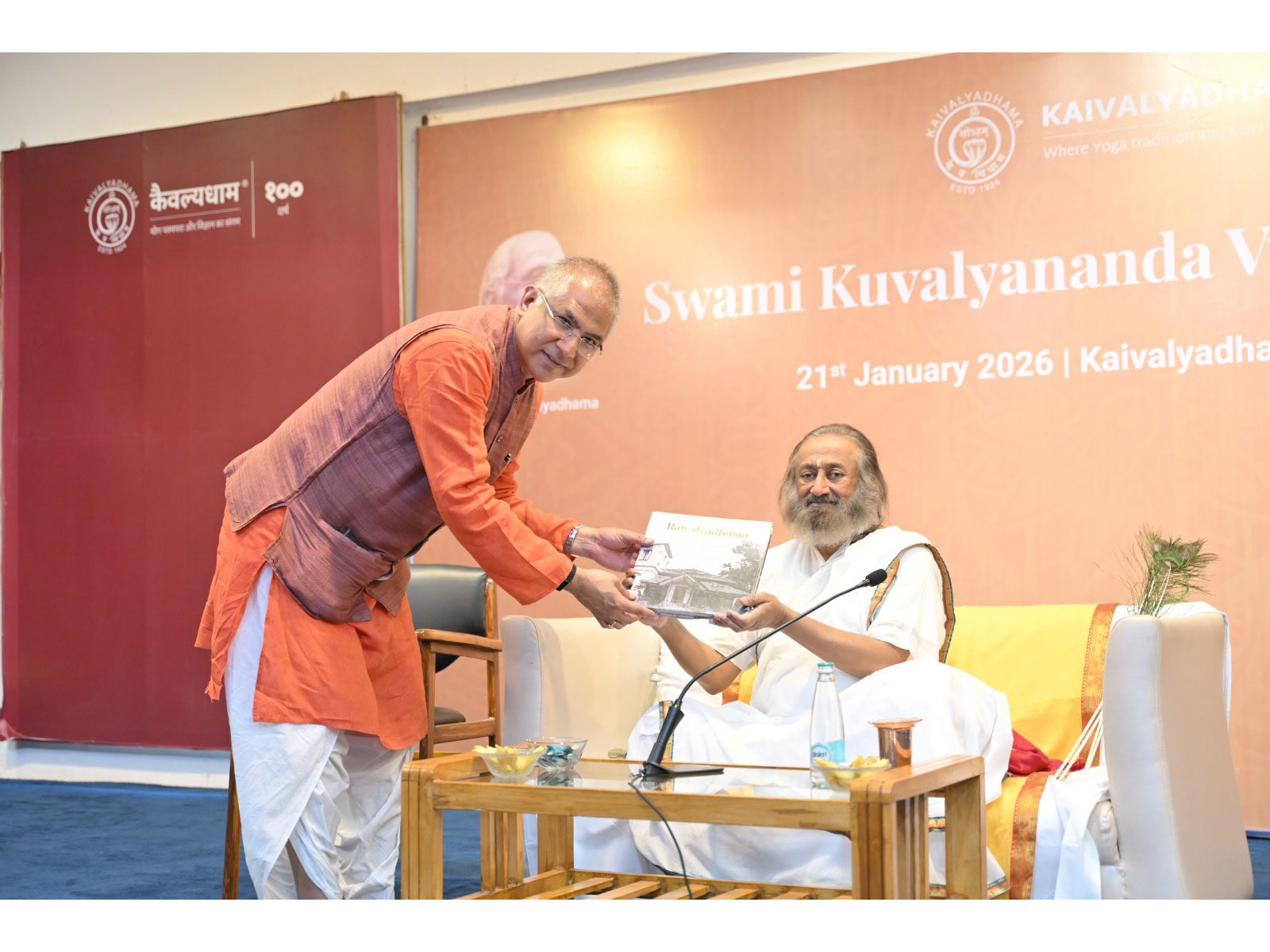 Subodh Tiwari presenting the Kaivalyadhama coffee table book to Gurudev Sri Sri Ravi Shankar