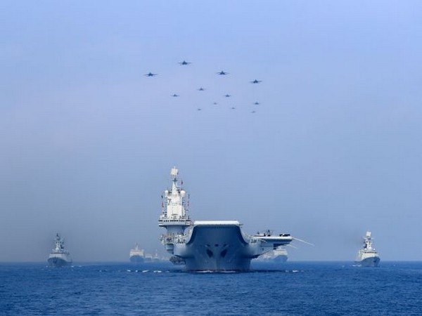 Warships and fighter jets of Chinese People's Liberation Army PLA Navy take part in a military display in the South China Sea. (Photo Credit - Reuters)