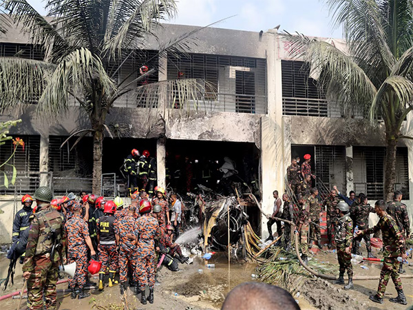 Firefighters and soldiers at the crash site of a Bangladesh Air Force training jet in Dhaka. (Source: Reuters)