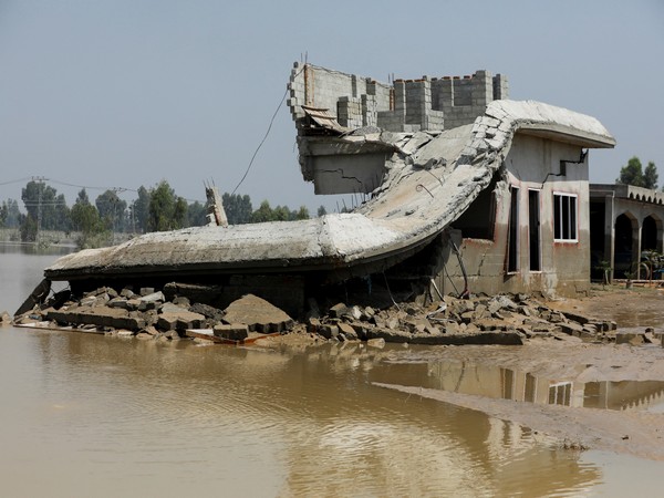 A collapsed building lies partially submerged after severe flooding in Pakistan (Source: Reuters)