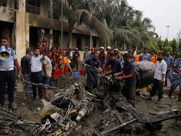 Firefighters work to remove the wreckage from a building, after an air force training aircraft crashed into Milestone College campus, in Dhaka (File Image/ANI)