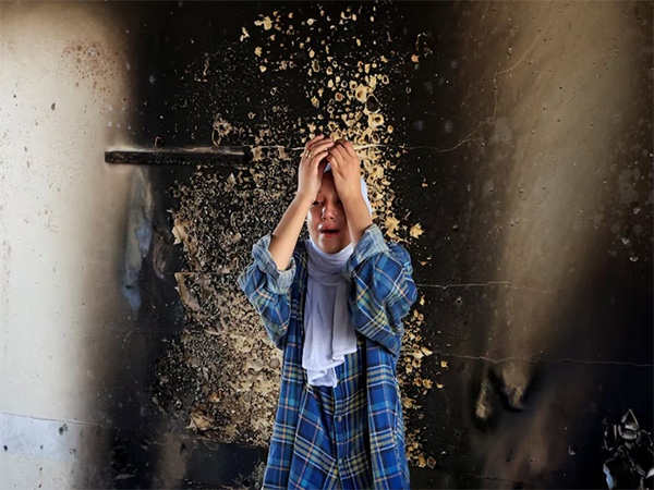Hala Al-Masri, 17, reacts at the site of an overnight Israeli strike on an UNRWA school that was sheltering displaced people, in Khan Younis, southern Gaza Strip (Image/Reuters)