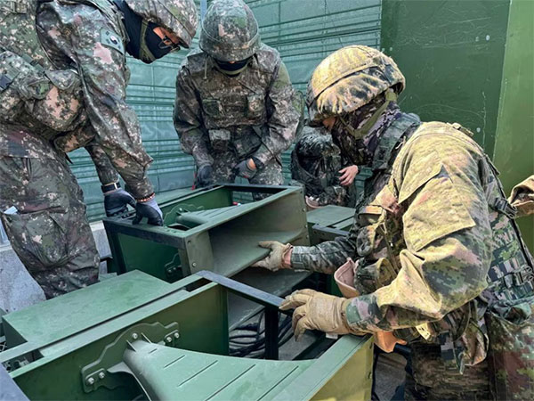 South Korean soldiers work on a loudspeaker that is set up for propaganda broadcasts (Image/Reuters)