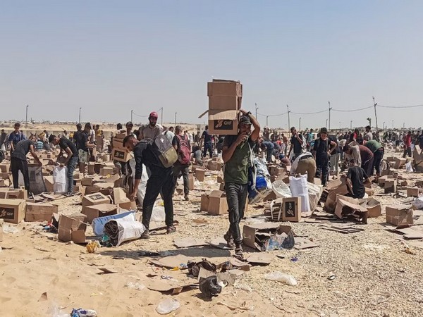 Palestinians gather to collect relief supplies from the US-backed Gaza Humanitarian Foundation's distribution centre in Rafah, southern Gaza Strip (File Photo/Reuters)