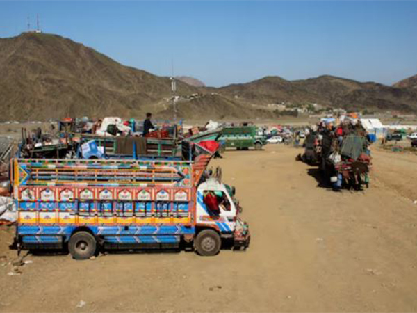 Trucks transporting Afghan nationals who were expelled from Pakistan await registration at the Omari refugee camp in Mohmand Dara, Torkham border, Nangarhar province, Afghanistan (Image/Reuters)