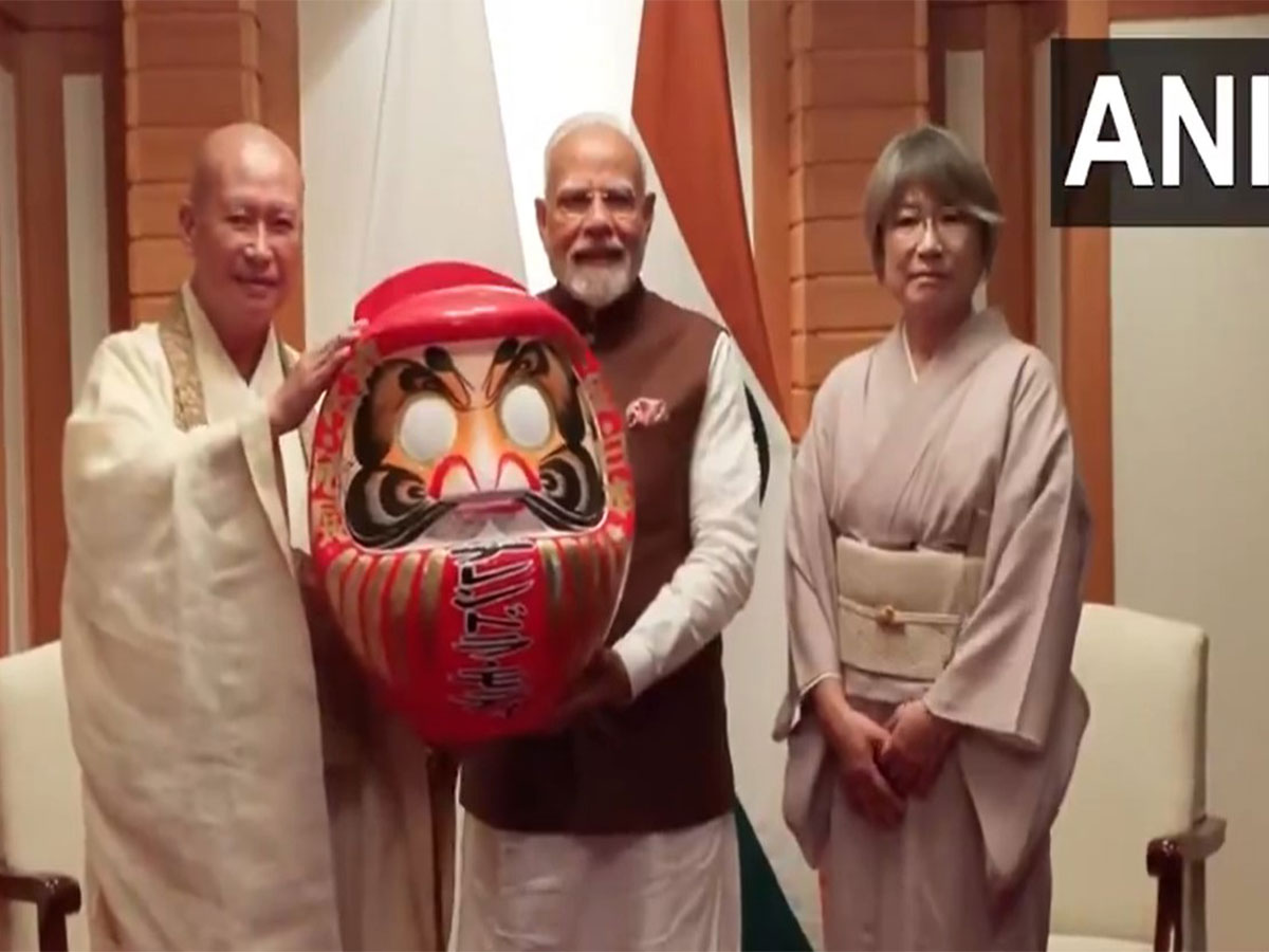 PM Modi was presented with a Daruma doll (Photo/ANI and DD)