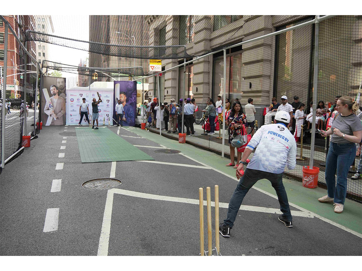 Passersby participated in a game of box cricket on Park Avenue, organized by Cricmax Connect