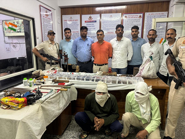 Visual of the arrested person with a huge stockpile of weapons. (Photo/Delhi Police)