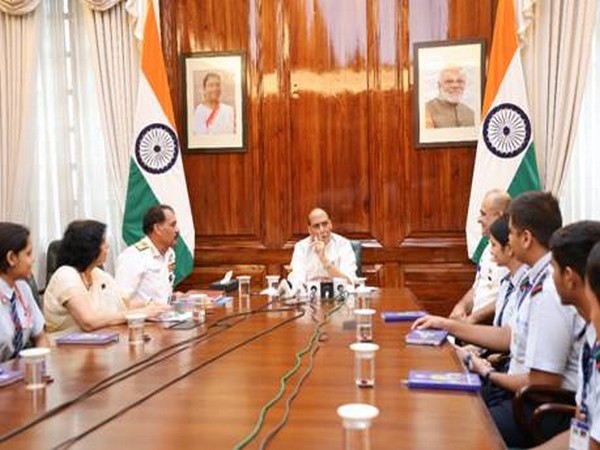Rajnath Singh interacts with students of Navy Children School. (Photo/ANI)
