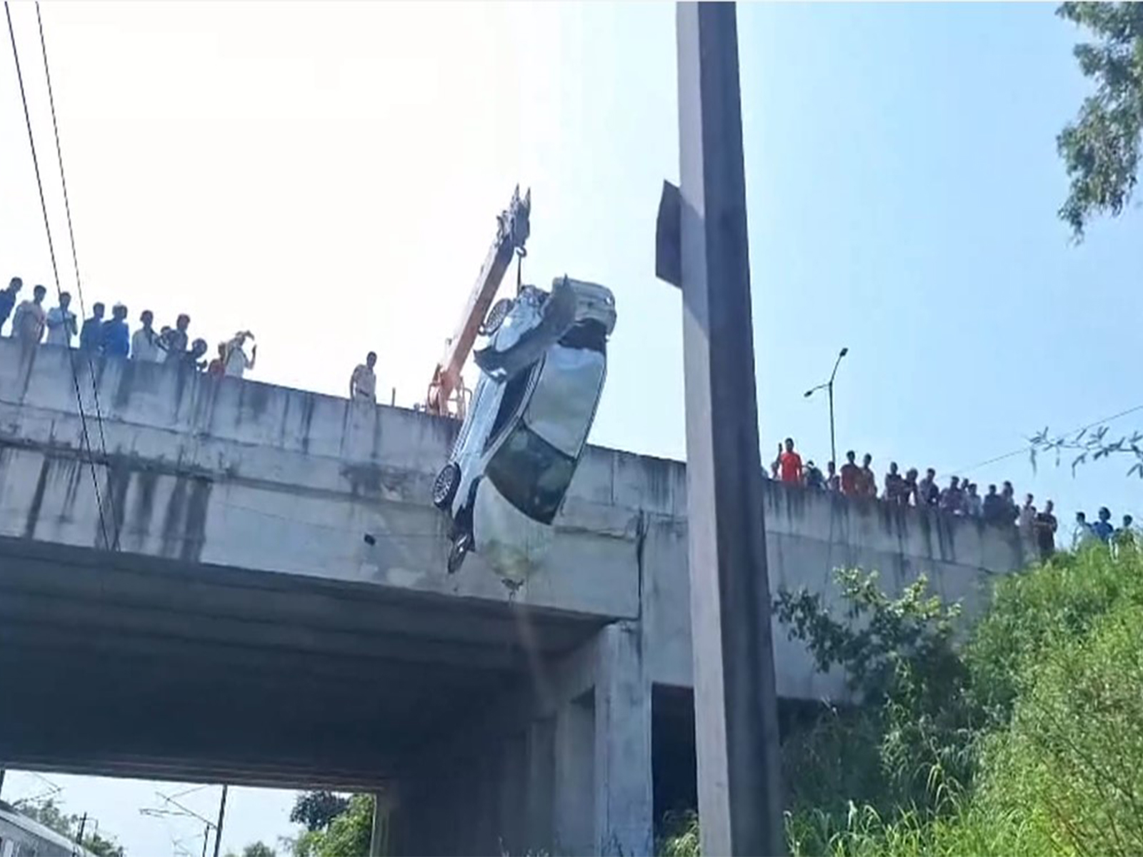 Car falls from Mukarba Chowk flyover onto railway tracks (Photo/ANI)