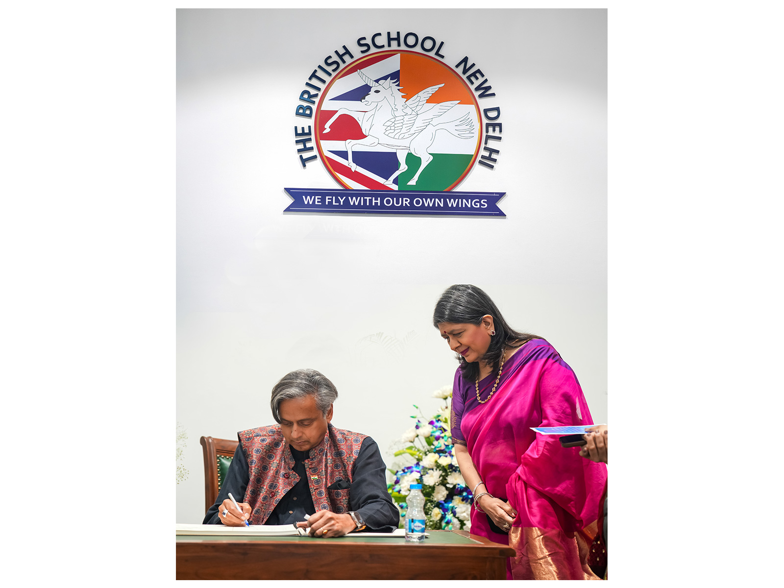 Dr Shashi Tharoor with Vanita Upal OBE, Director of The British School New Delhi, penning a message for the school community at IB@20: Inspiring Futures