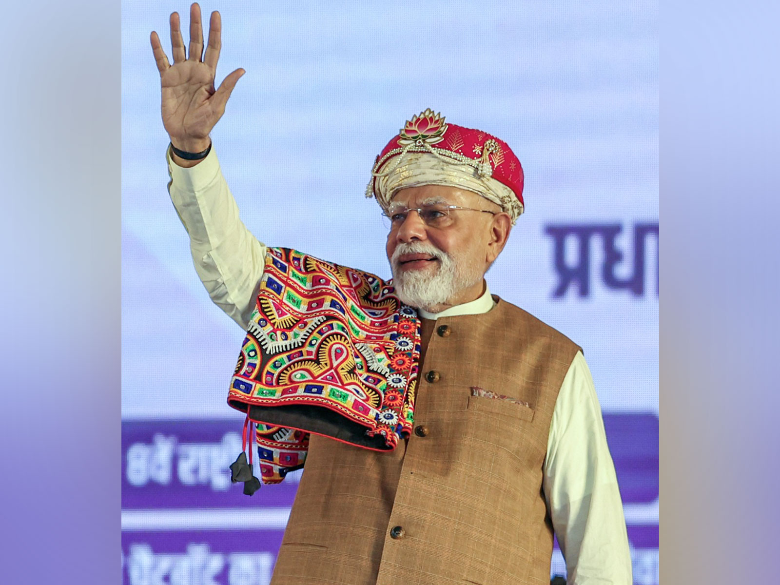 PM Narendra Modi waves at a public gathering in Dhar (Image/ANI)