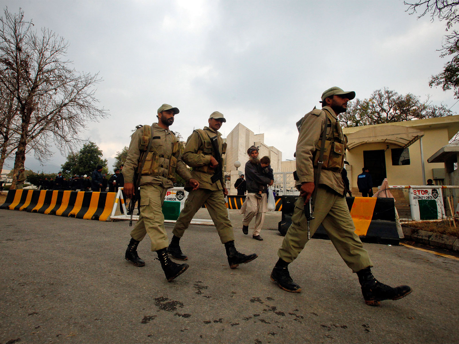 Paramilitary personnel walk past the Supreme Court building in Islamabad (File Photo/Reuters)