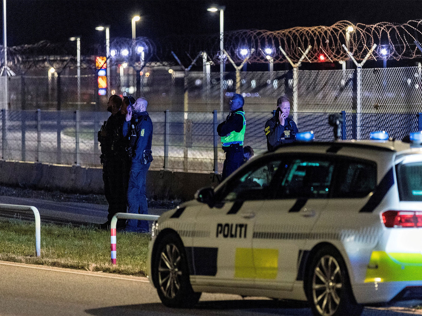 Police officers stand guard as traffic is halted at Copenhagen Airport following drone sightings in Denmark (Photo/Reuters)