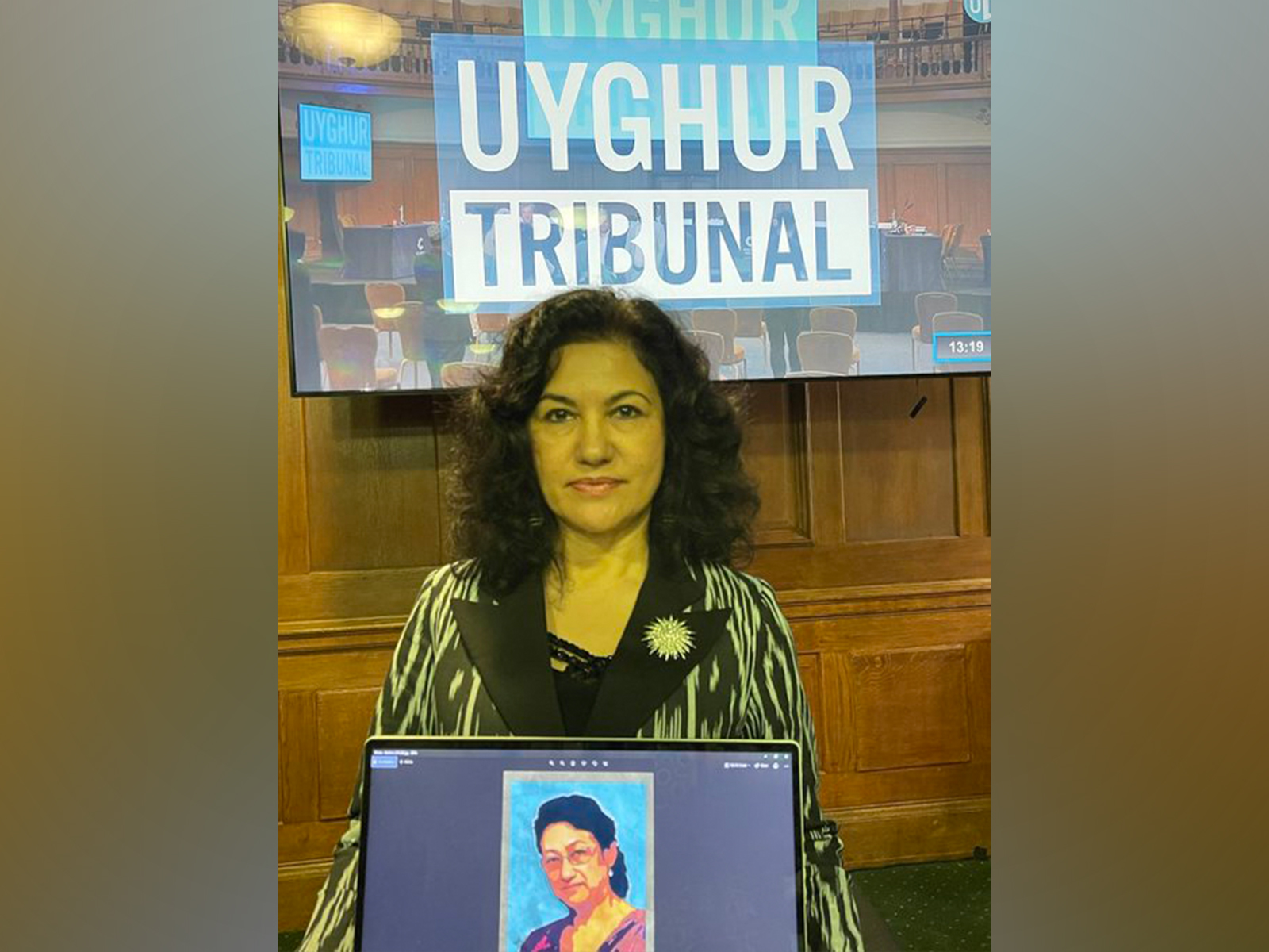Rushan Abbas, Founder and Executive Director of the Campaign for Uyghurs, holds a picture of her sister Dr Gulshan Abbas, imprisoned in China (Image: X/@RushanAbbas)