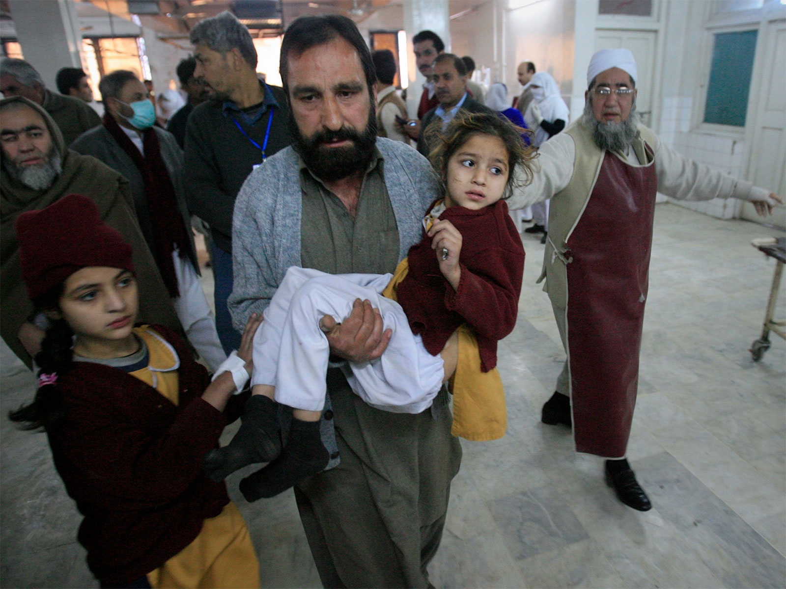A man carries a student, who was injured during bomb blast (File Photo/ANI)