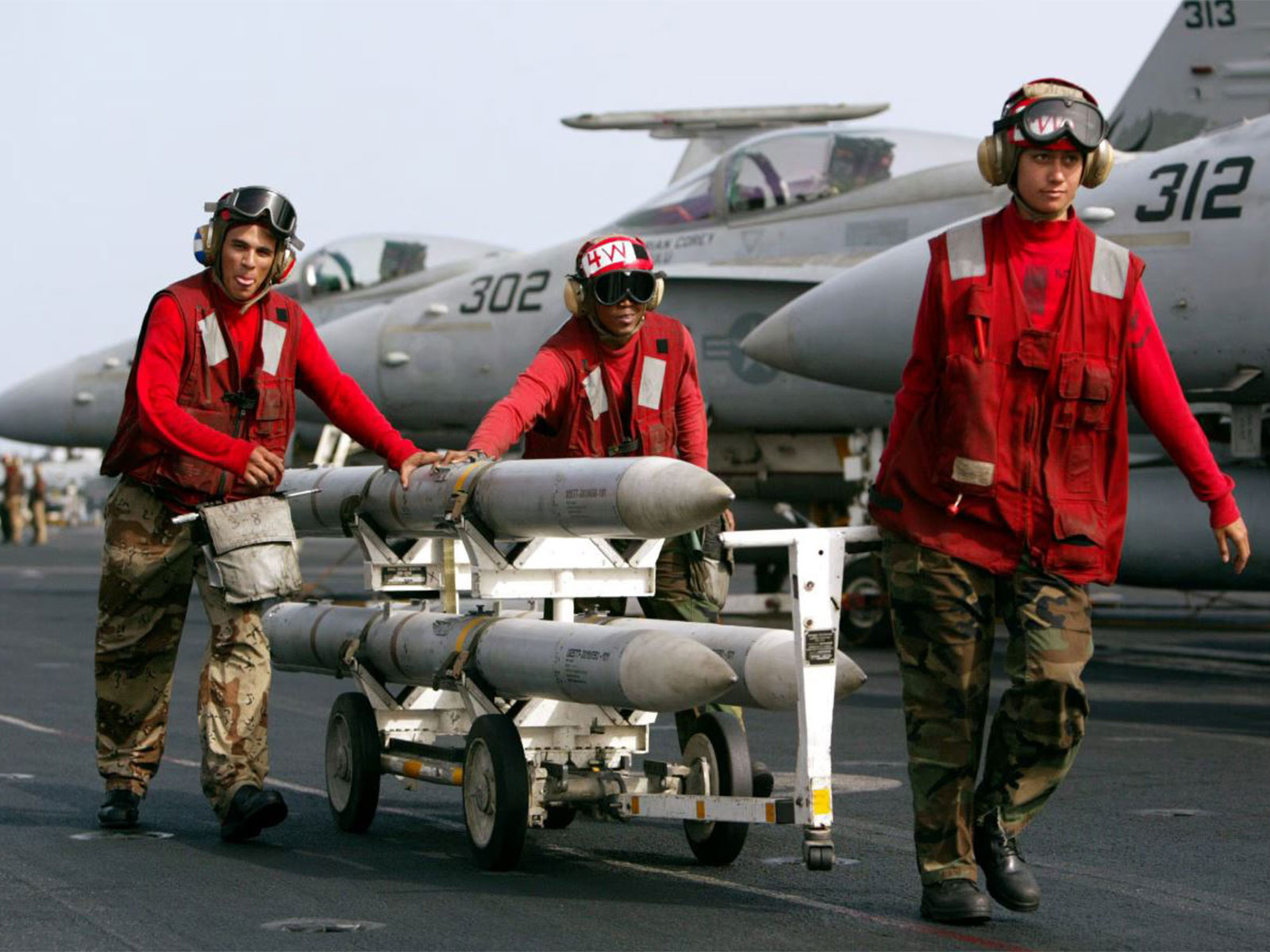   AIM-120 AMRAAM air-to-air intercept missiles are wheeled past fighter jets on the deck of the USS Kitty Hawk (File Photo/ Reuters)