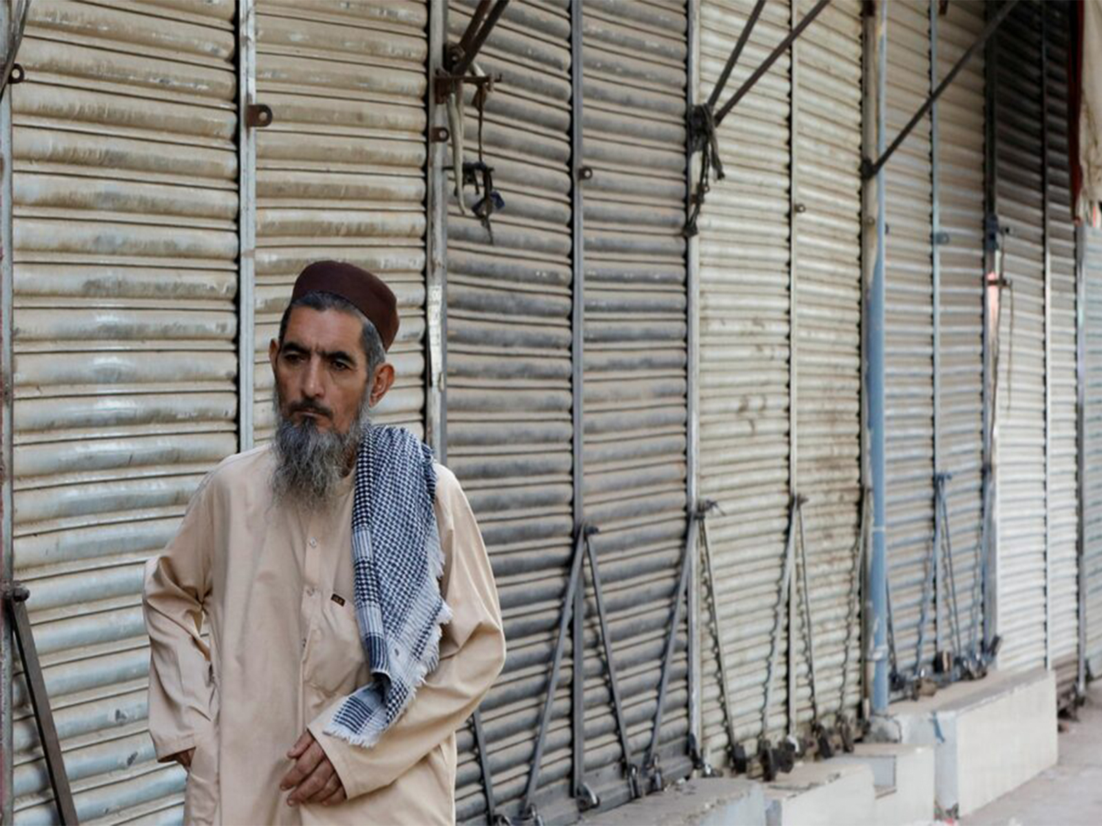 A man walks along closed market, during a shutter down and wheel-jam strike called by the traders (File Photo/ Reuters)