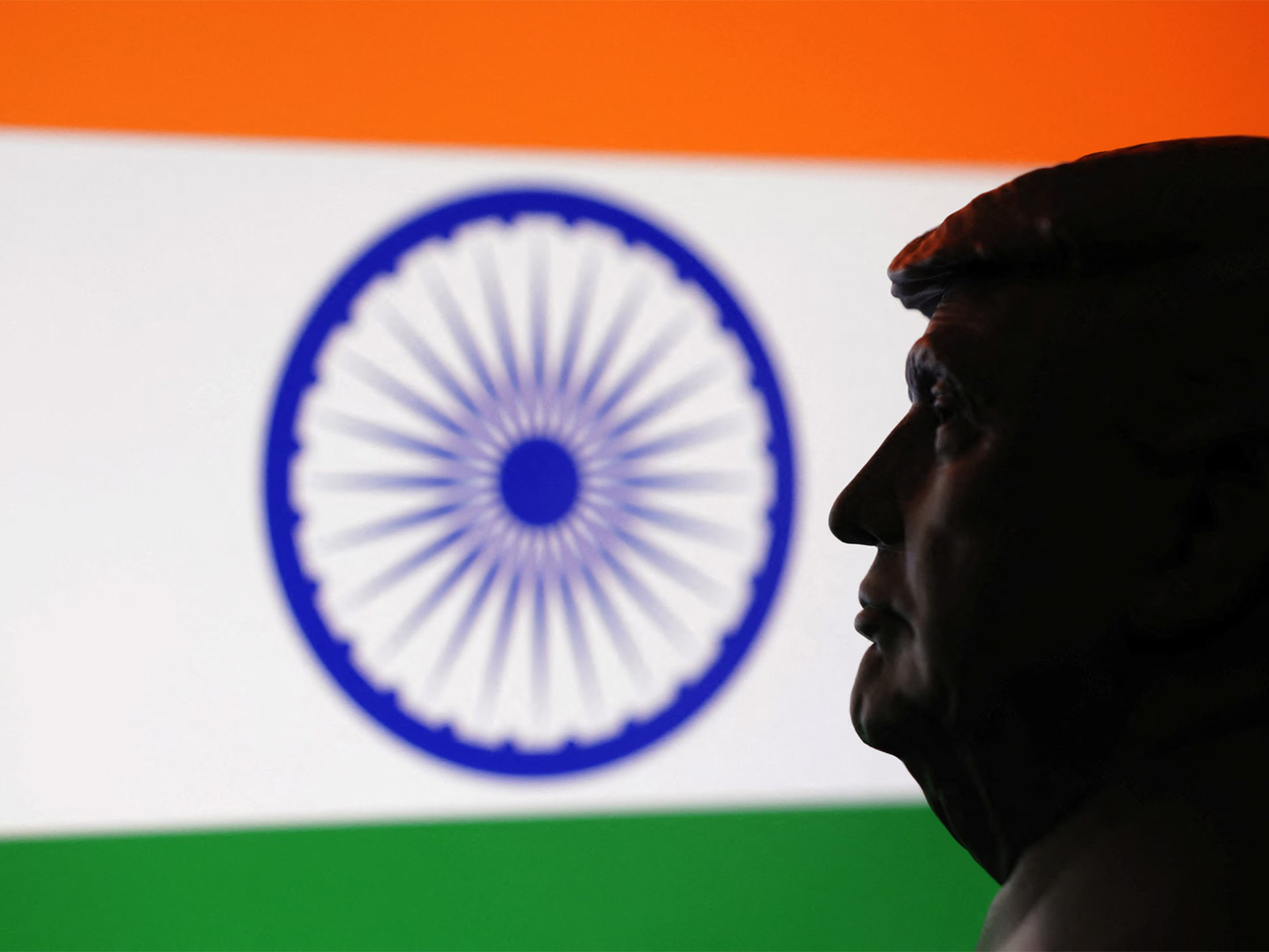 A 3D-printed miniature model of US President Donald Trump is seen alongside the Indian flag in this illustration. (Photo/Reuters)