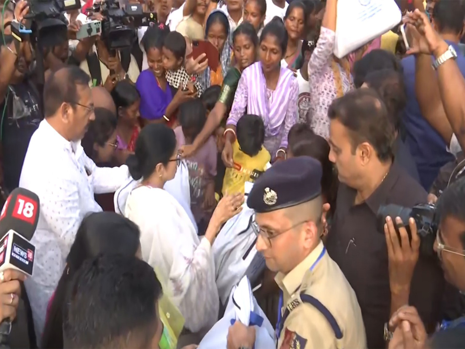 CM Mamata Banerjee distributes relief material in Hasimara. (Photo/ANI) 