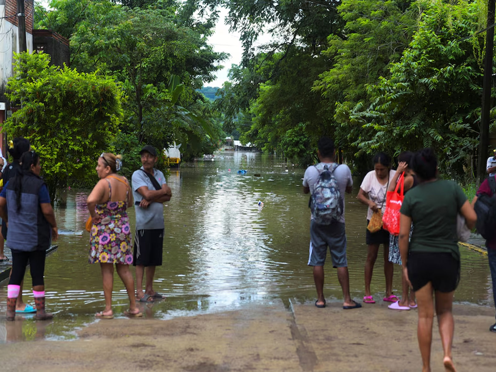 People look at a flooded street after torrential rains that caused an overflow of rivers in Poza Rica, Veracruz state, Mexico (Photo/Reuters)