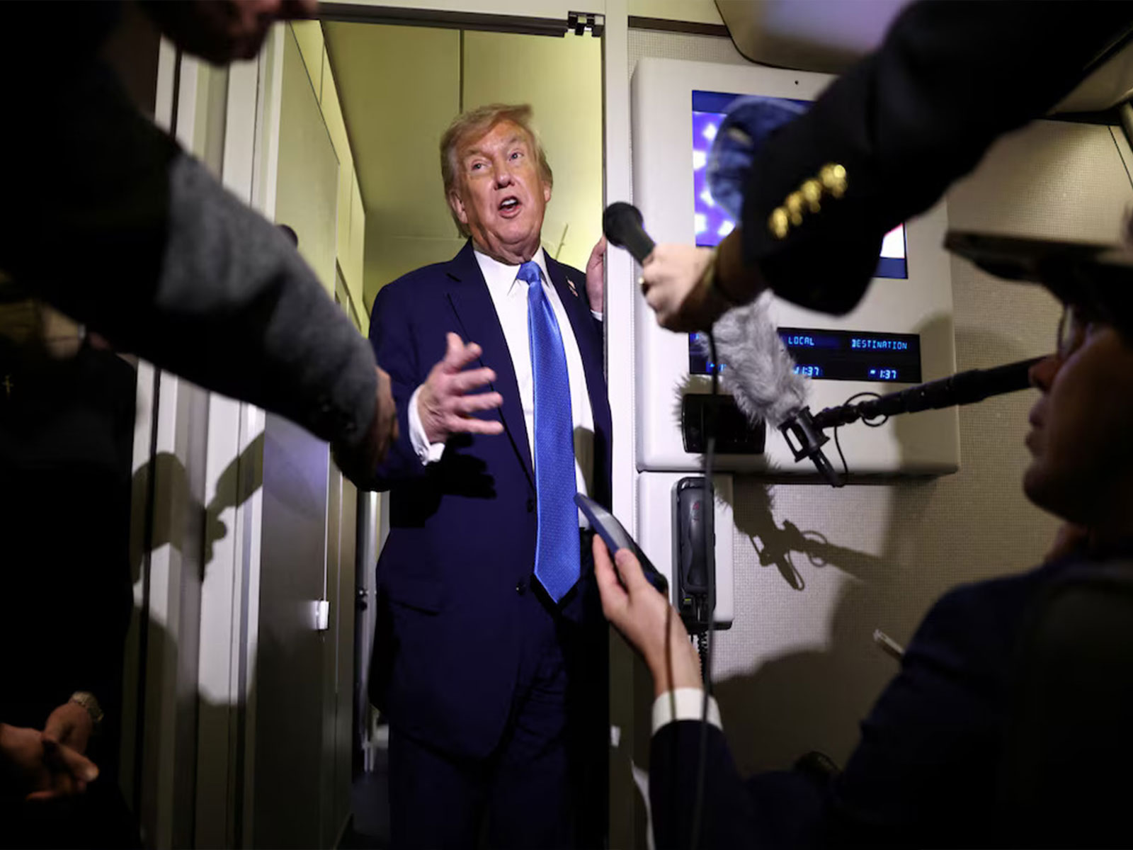 US President Donald Trump speaks to reporters aboard Air Force One (Photo/Reuters)