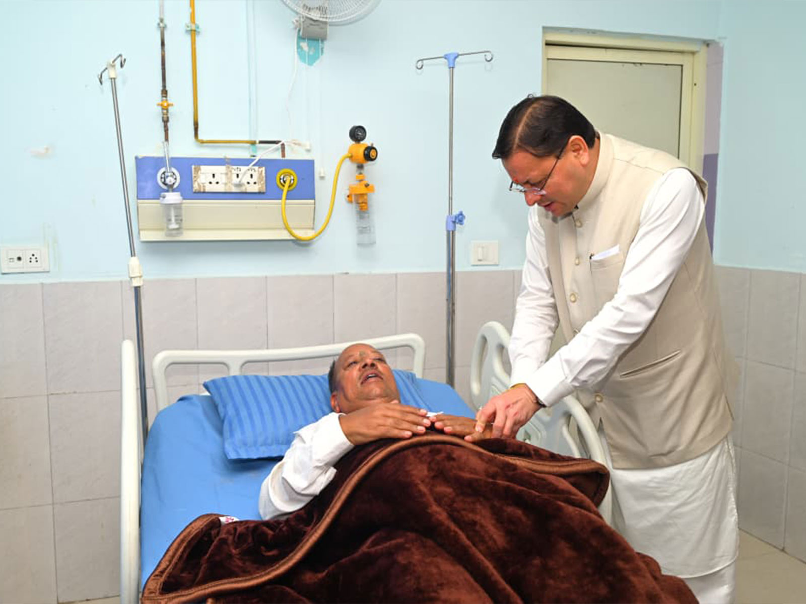 Uttarakhand CM visiting MLA Fakir Ram in hospital (Photo/ANI)