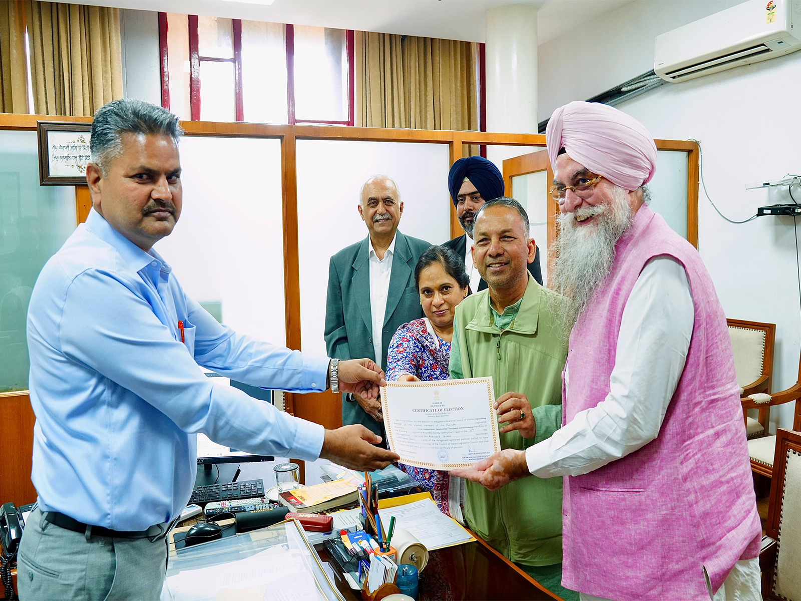 Punjab Vidhan Sabha Secretary Ram Lok Khatana hands over certificate of Election to Rajya Sabha candidate Rajinder Gupta (Source-Information and Public Relations Department, Punjab)