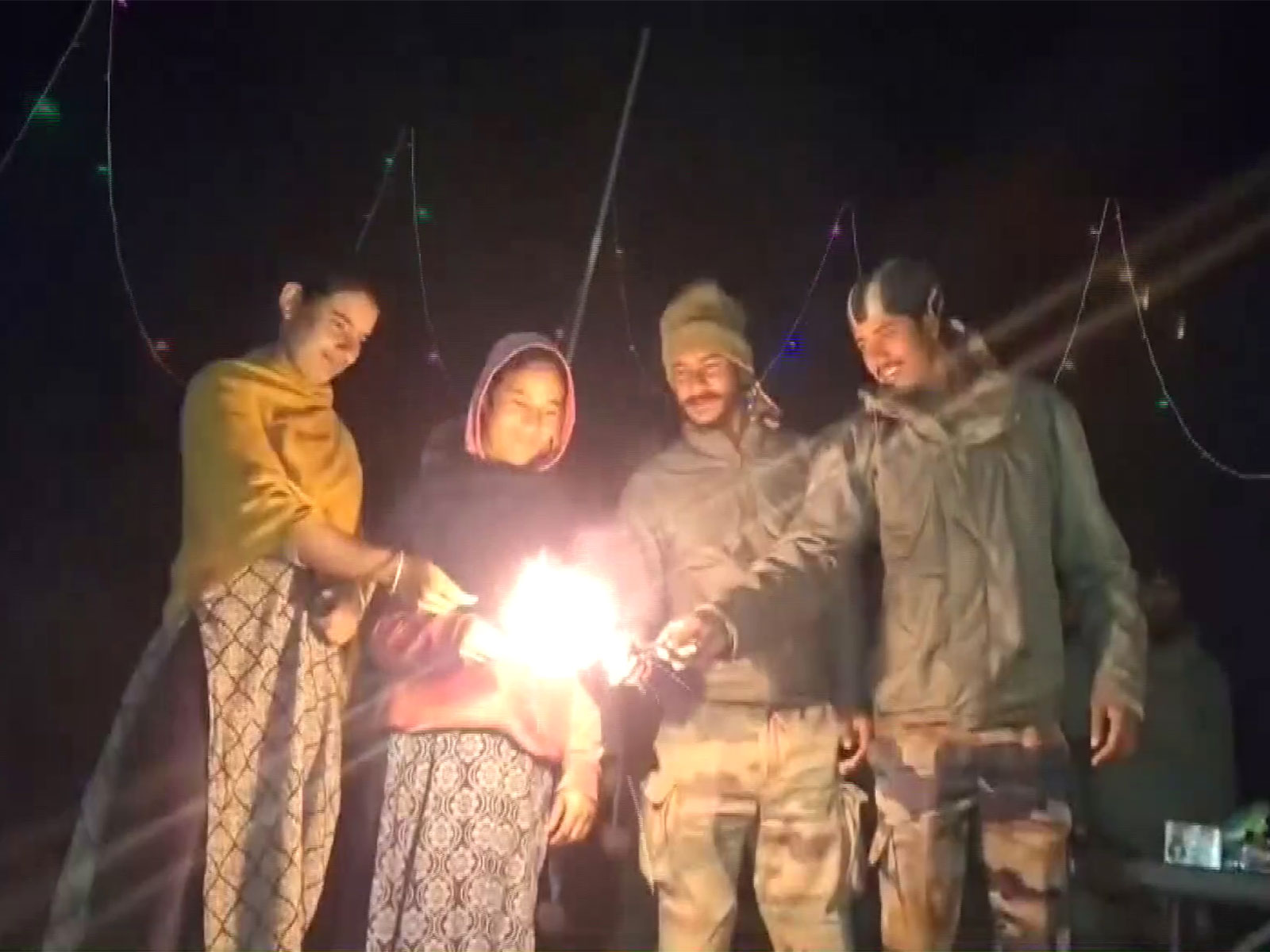 Indian Army jawans celebrates Diwali with local people of Bani village in Kathua, J&;K. (Photo/ANI)