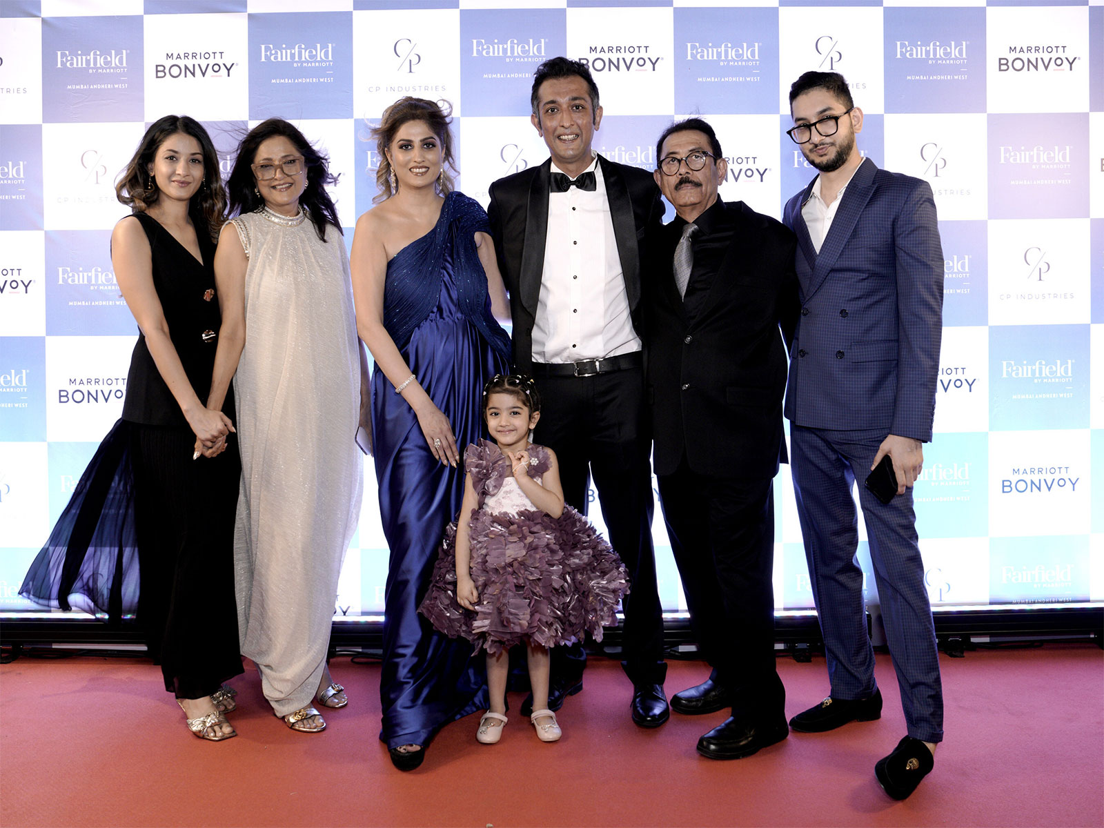 (L-R) Richa Patel, Alka Patel, Urvashi Patel, Karan Patel, Dinesh Patel, Aakash Patel, and Natali Patel (center), daughter of Karan and Urvashi Patel, at the launch event.