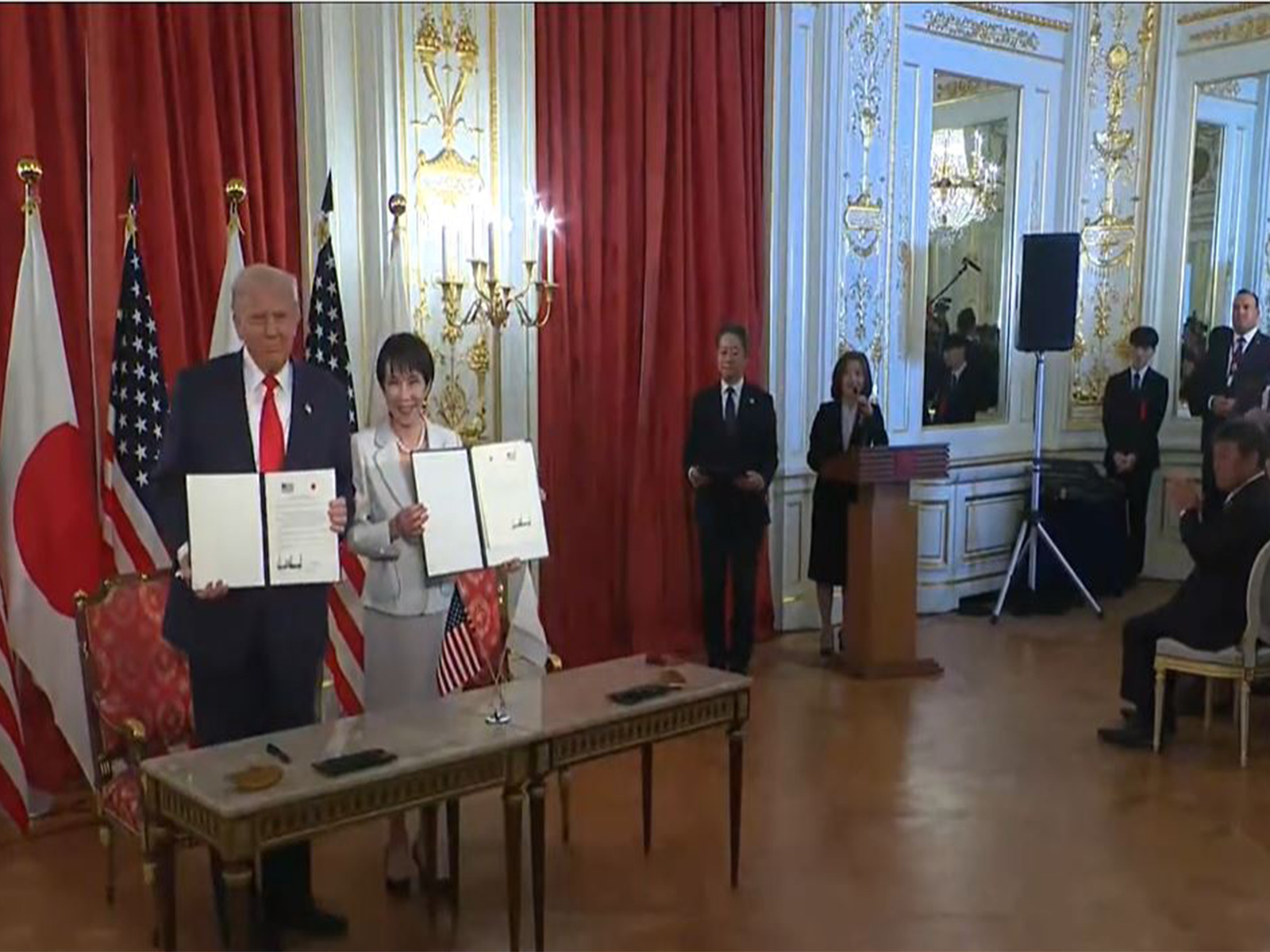 US President Donald Trump and Japanese Prime Minister Sanae Takaichi hold signed agreements during a ceremony in Tokyo. (Image: The White House/YouTube)