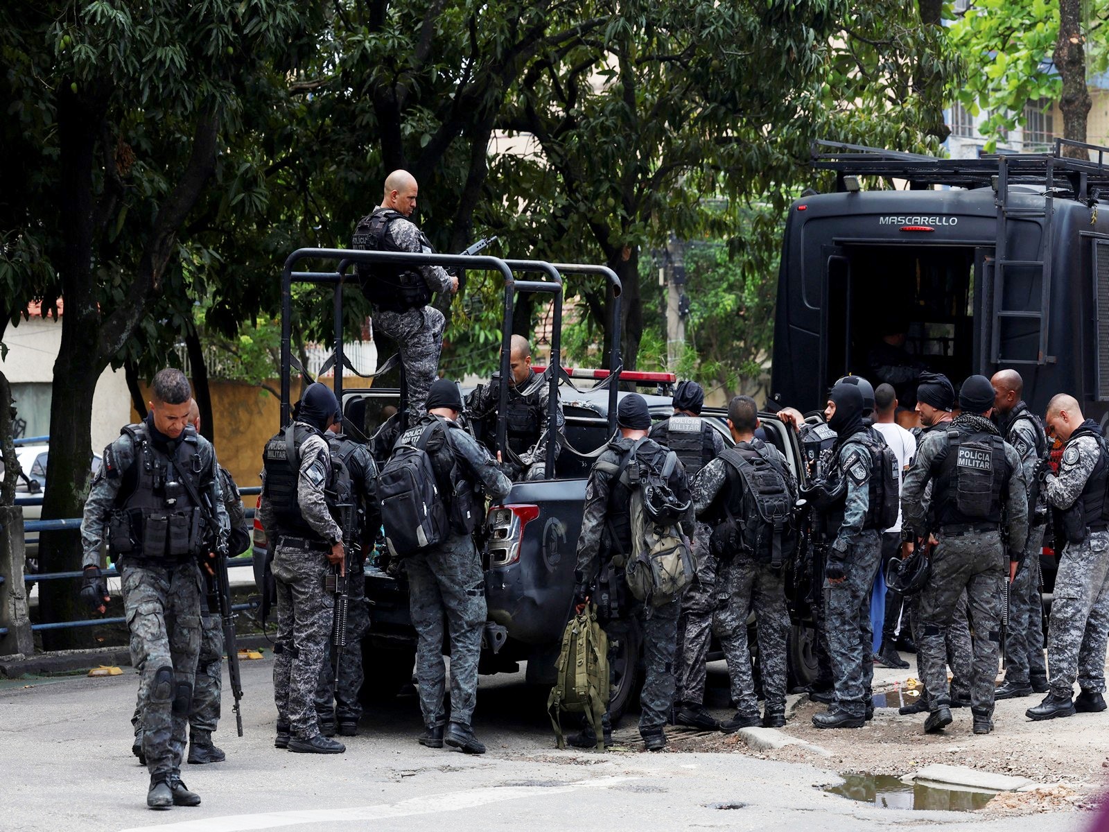 Members of the military police special unit gather to detain suspected drug dealers during a police operation against drug trafficking at the favela do Penha, in Rio de Janeiro, Brazil (Photo/Reuters)