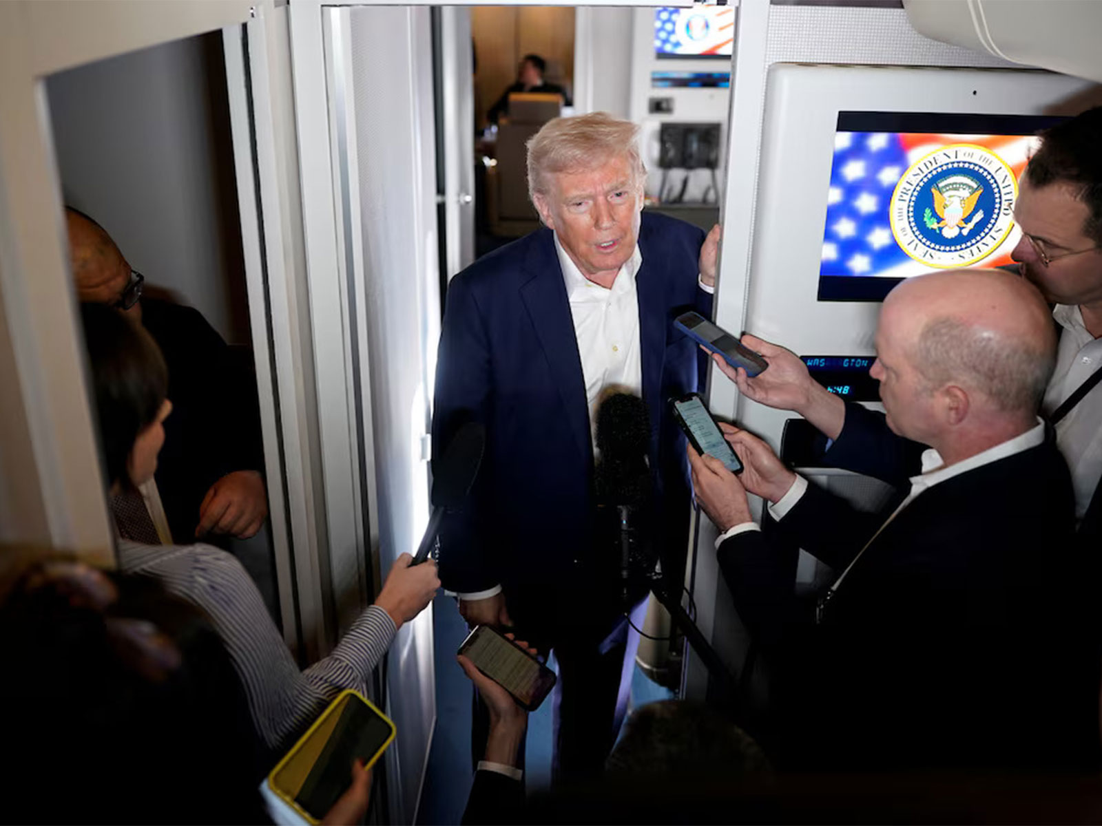 US President Donald Trump speaks to reporters aboard Air Force One during a press gaggle. (File Photo/Reuters)