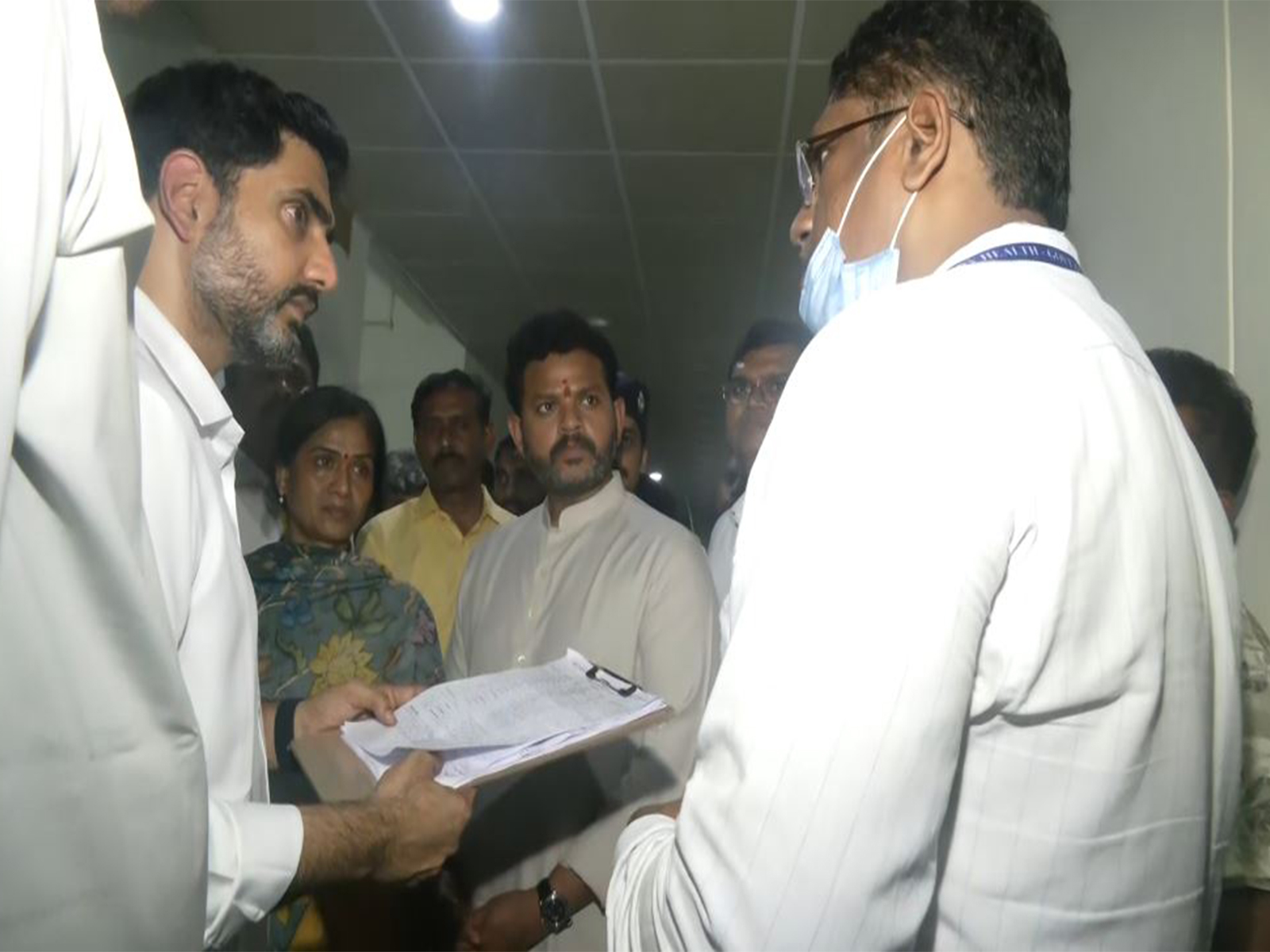 Union Minister Ram Mohan Naidu Kinjarapu and Andhra Pradesh Minister Nara Lokesh interacting with a doctor after meeting the injured people at a hospital (Photo/ANI)