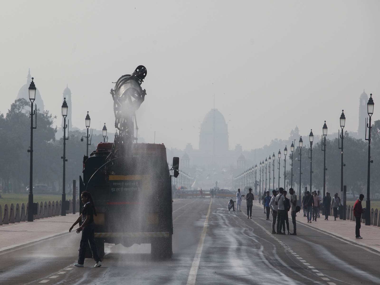An anti-smog gun sprays water droplets across Delhi. (Photo/ANI)