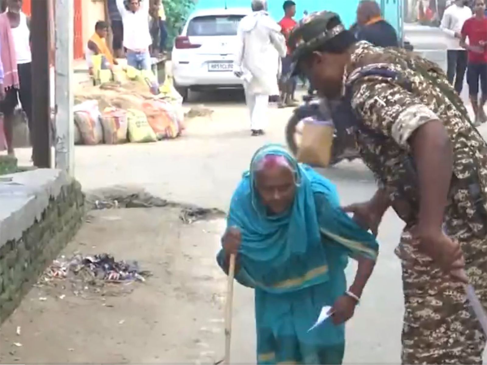 Elderly woman helped by security personnel (Photo: ANI)