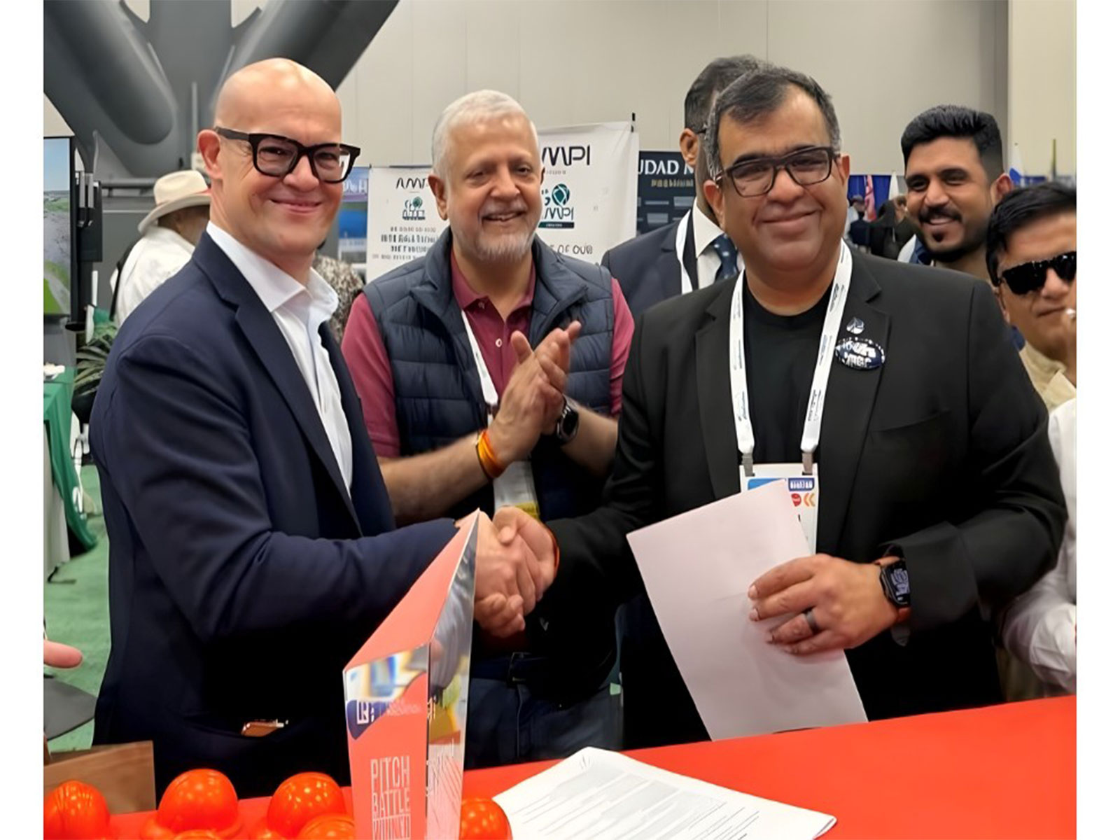 Mr Christian Calusa, Founder & CEO of NEO, and Mr Tarun Bhatia, Vice Chairman of NAR India, seal the MoU with a handshake at NAR NXT Houston
