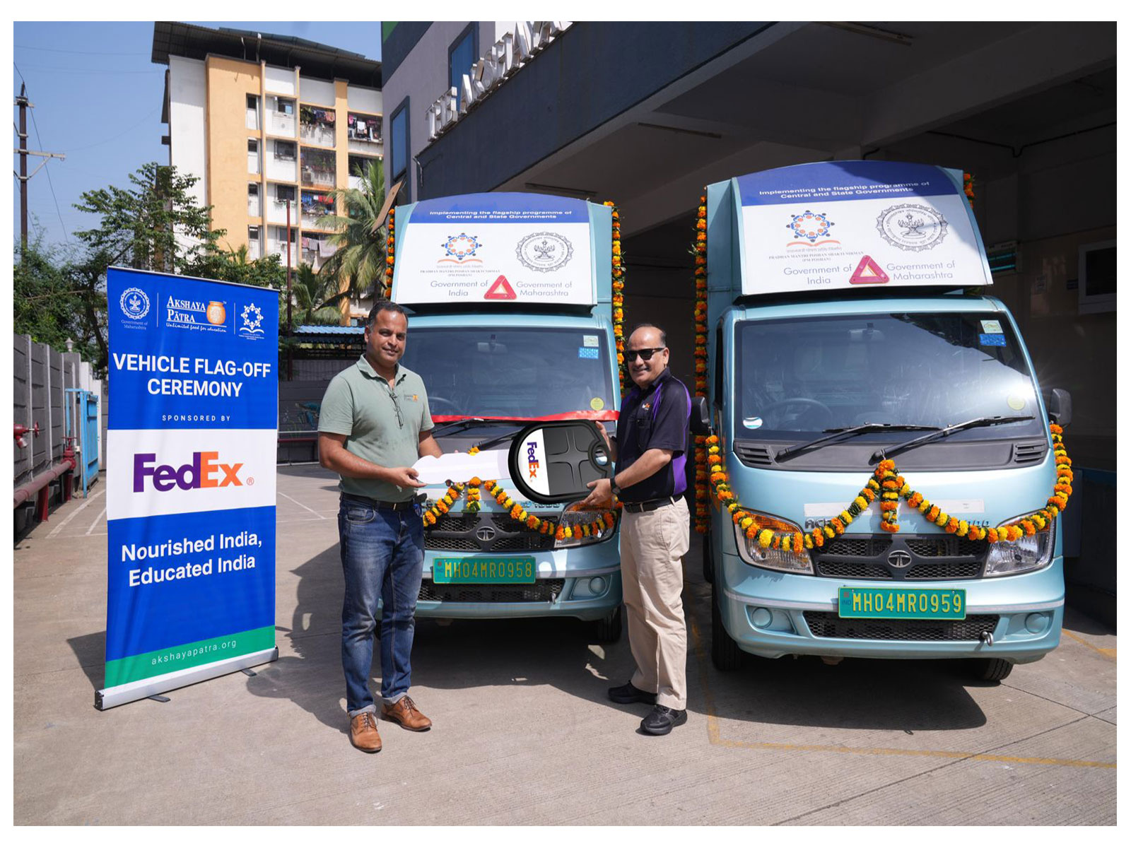 Ramkrishna Kamath and Monish Nandi, inaugurating the new electric vehicles, purchased with a donation from FedEx