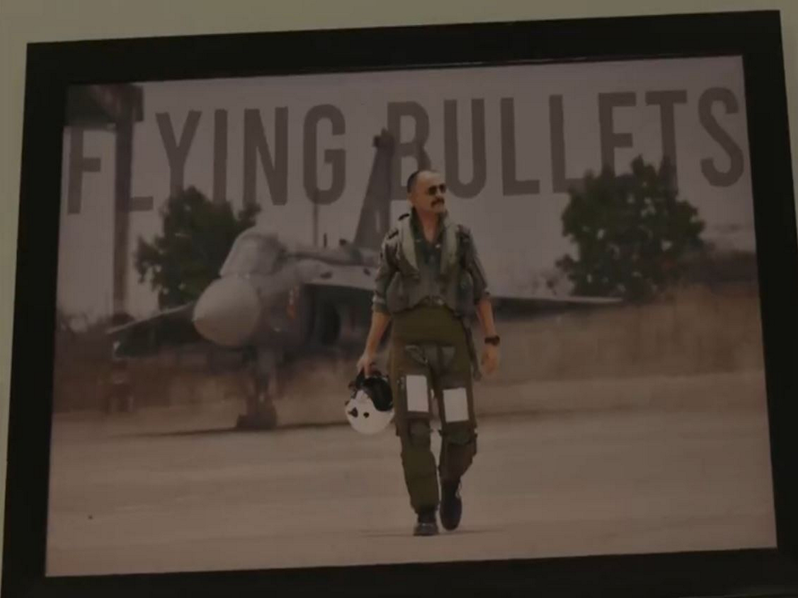 Wing Commander Naman Syal's photo in a frame at his native village Patiyalkar in Kangra (Photo/ANI)