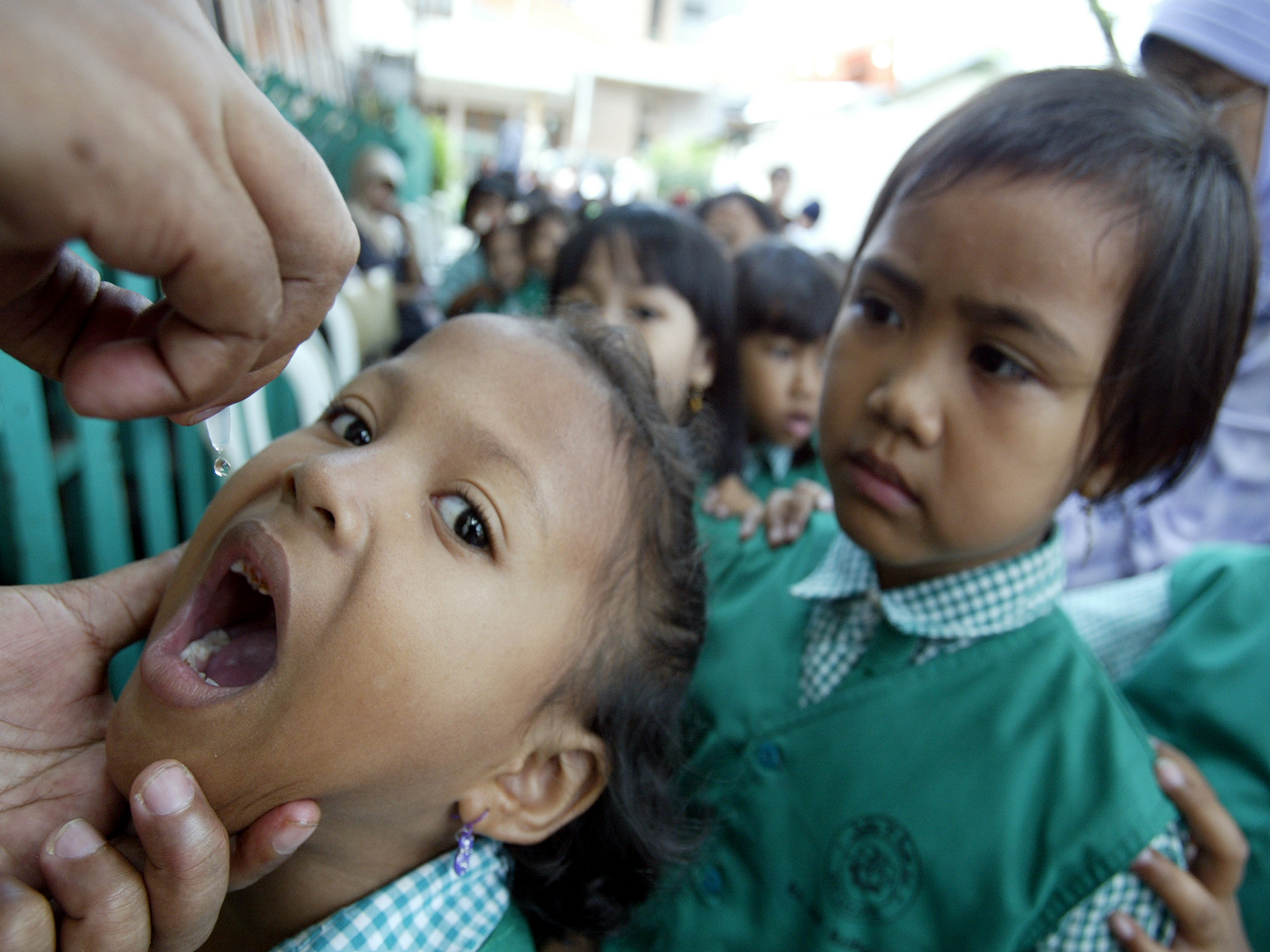 An Indonesian child receives a polio dose in school in Jakarta (File Photo/Reuters)