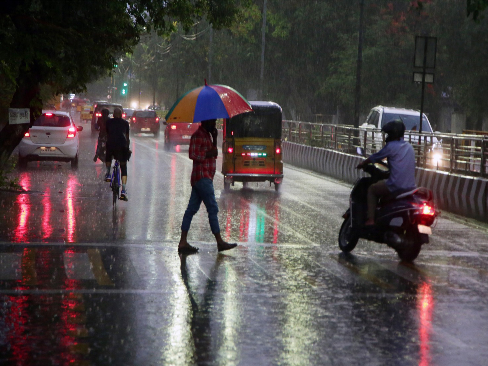 Commuters make their way during rain in Chennai (Photo/ANI)