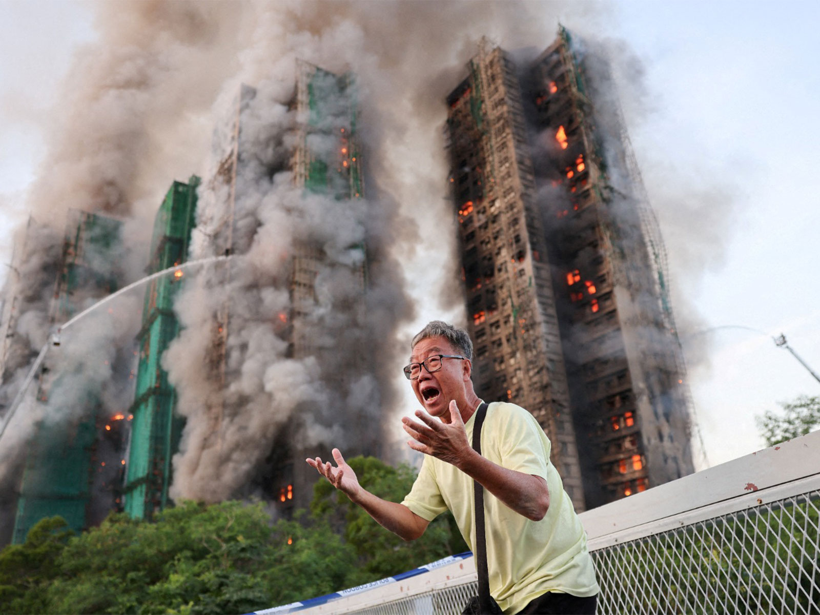 Hong Kong resident reacts after claiming his wife is trapped inside during a major fire, in Tai Po, Hong Kong (Photo/Reuters)