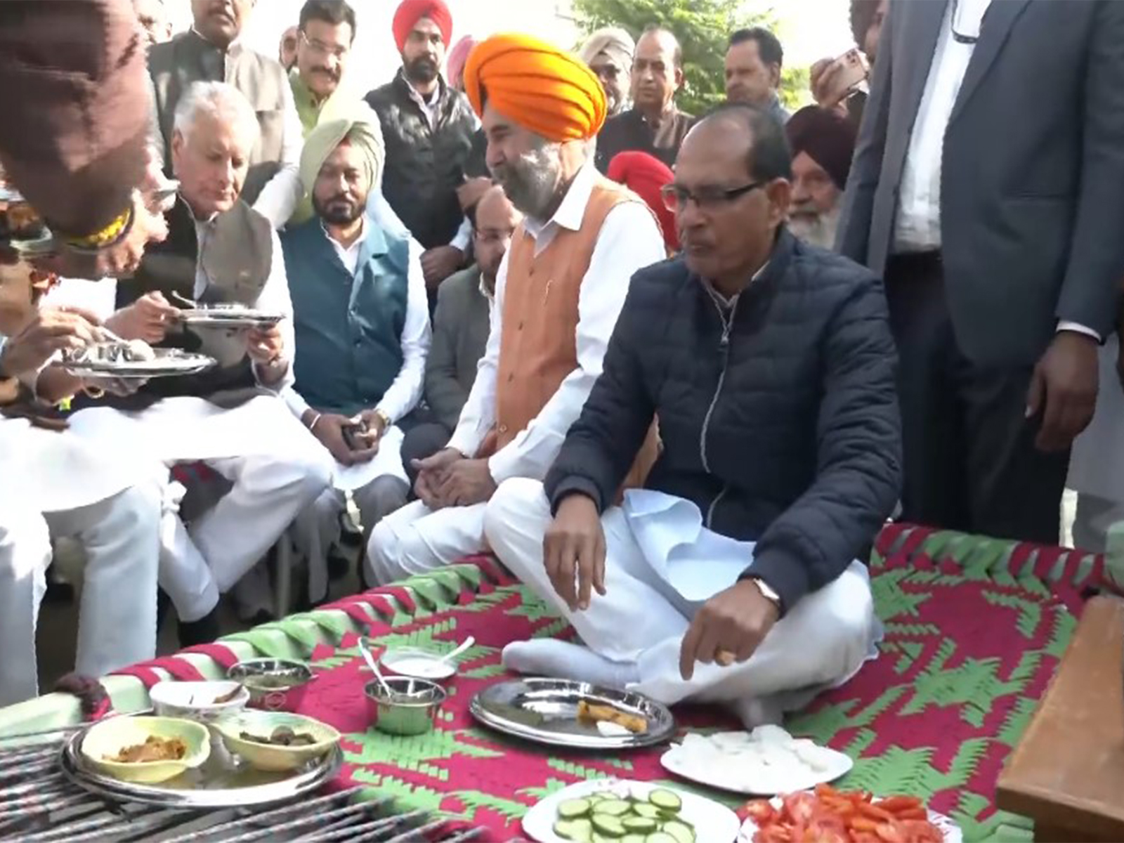 Union Minister Shivraj Singh Chouhan having a meal with the locals of Ransih Kalan village in Moga, Punjab on Thursday. (Photo/ANI)