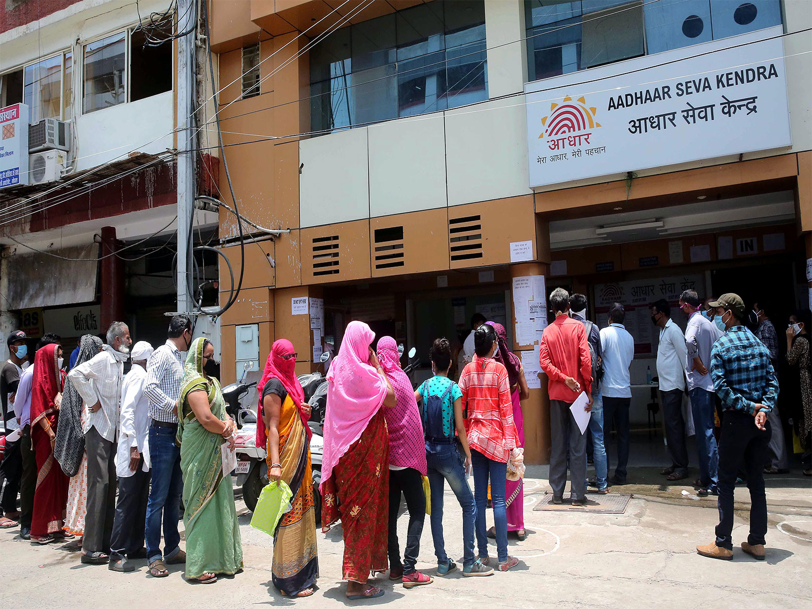 People queue outside an Aadhaar service centre (Photo/ANI)