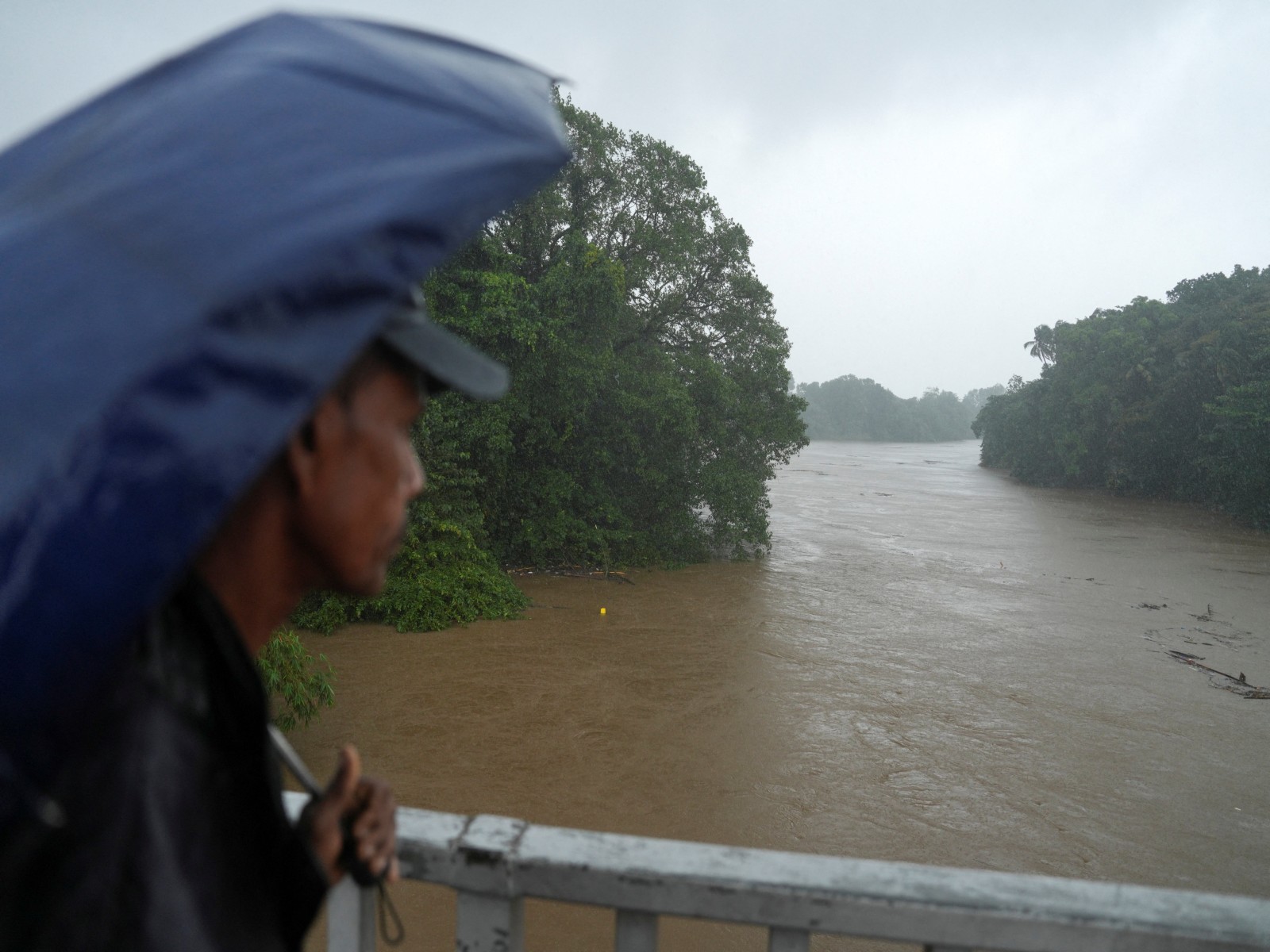 A man looks towards the swollen Kelani river, following heavy rainfall in Kelaniya A man looks towards the swollen Kelani river, following heavy rainfall in Kelaniya, Sri Lanka (Photo/Reuters)