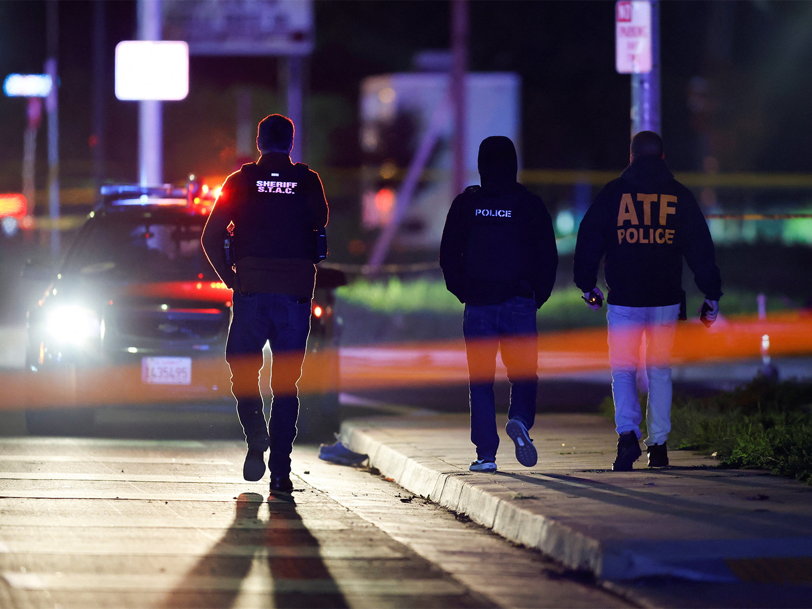 Members of the police walk at the scene after several people were shot at a family gathering in Stockton, California (Photo/Reuters)