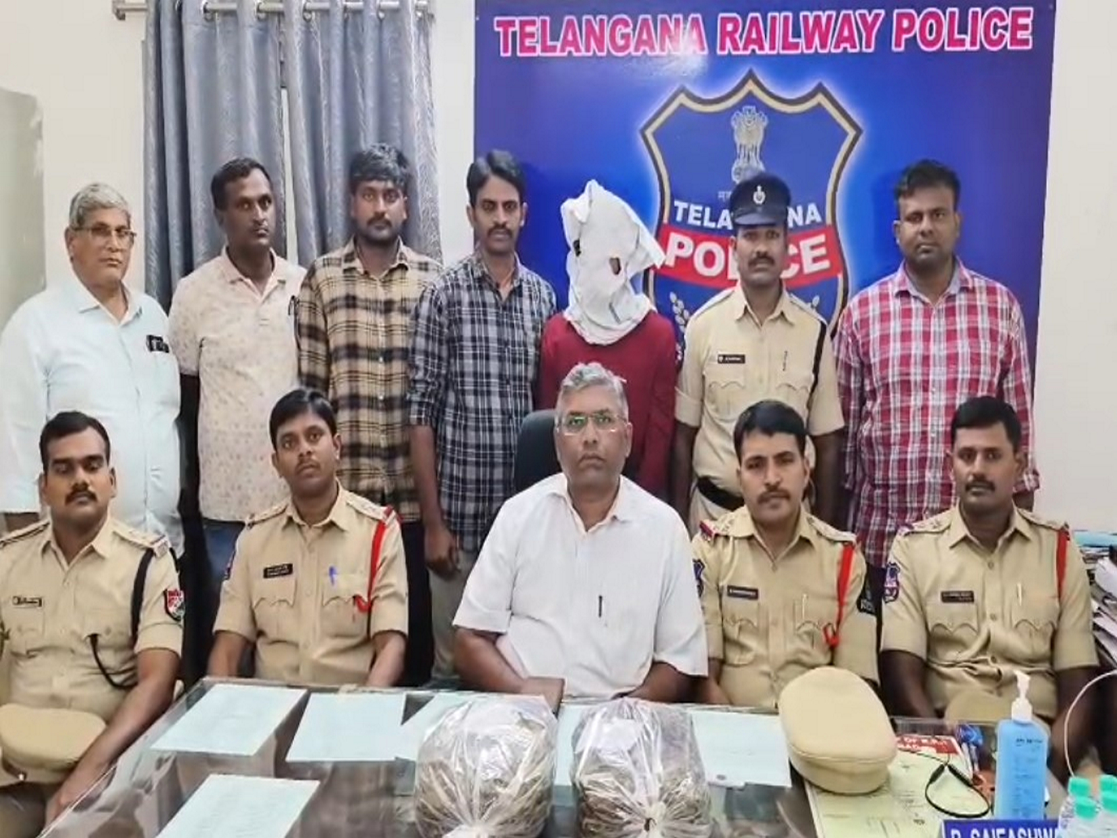 Telangana Railway Police officials with the accused ganja peddler in Secunderabad on Monday. (Photo/ANI)