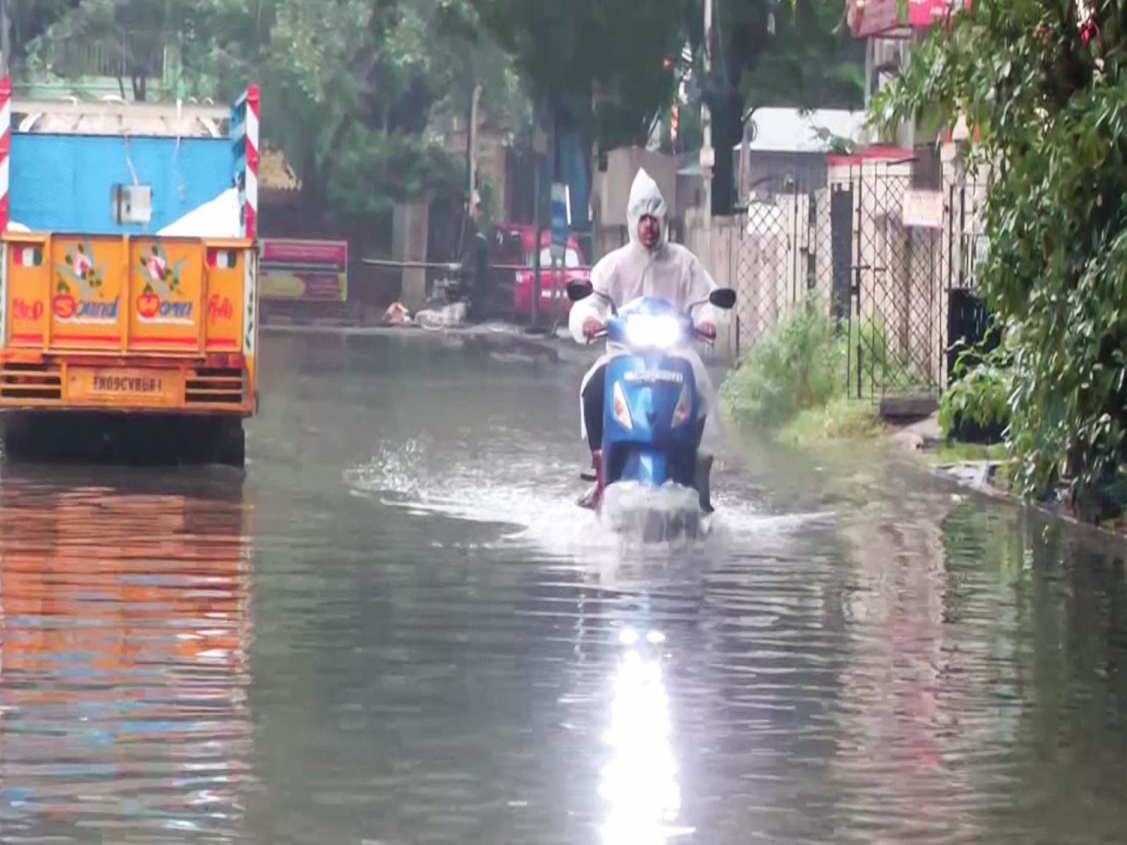 A commuter paves way through a waterlogged street due to heavy rainfall triggered by Cyclone Ditwah (Photo/ANI)