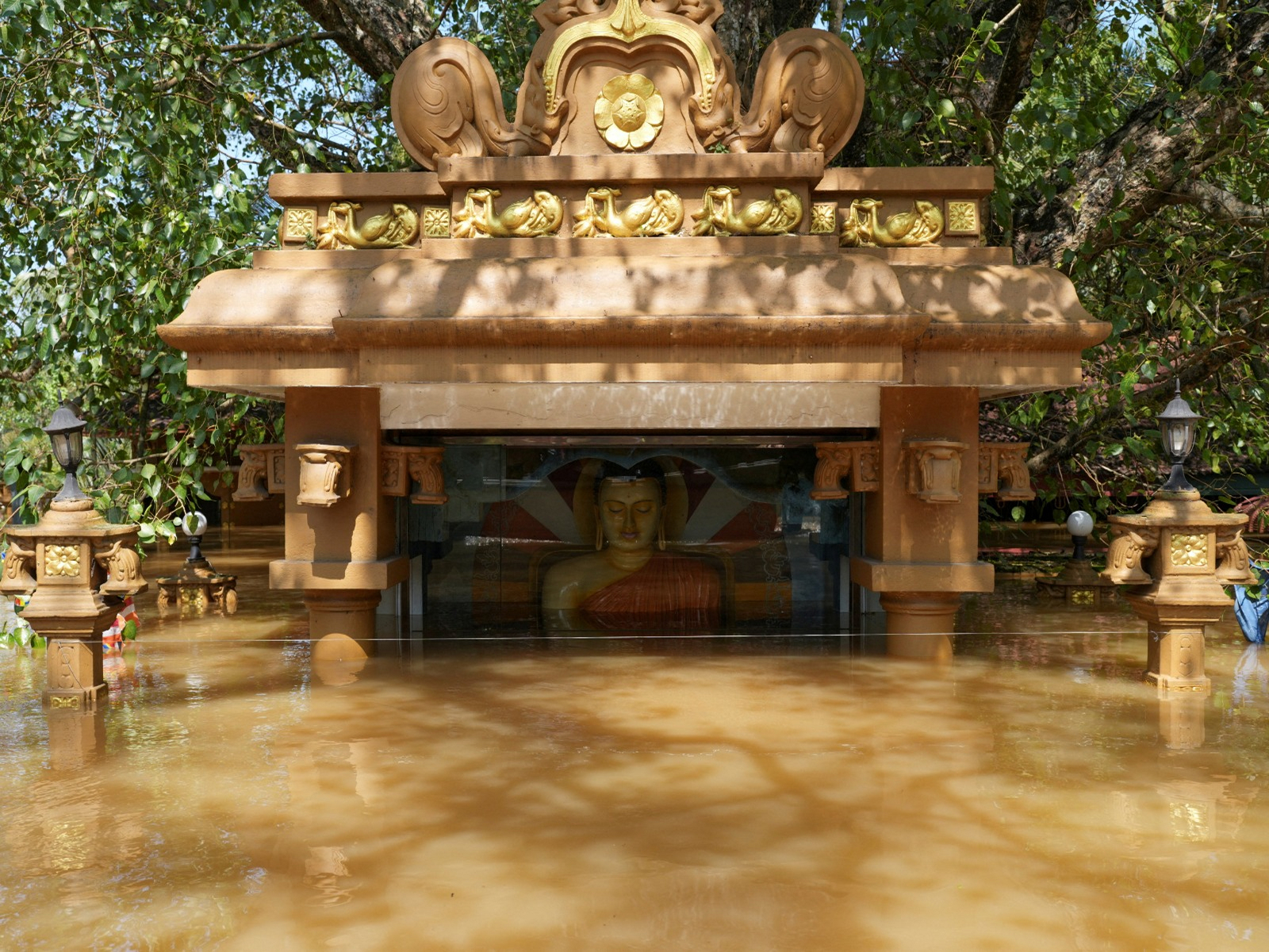 A partially submerged statue of Buddha in a flooded area, following Cyclone Ditwah in Sri Lanka (Photo/ Reuters)