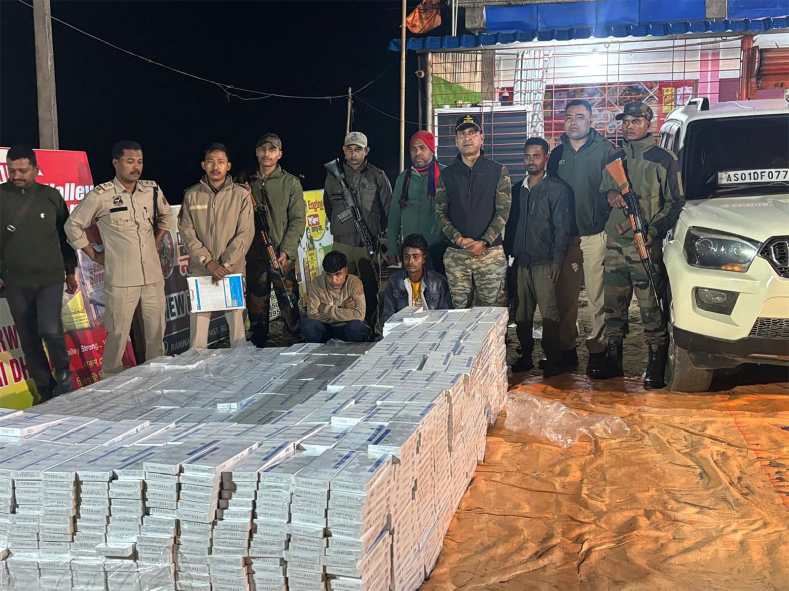 Assam Rifles with stacks of recovered illegal cigarettes in Cachar (Photo: Assam Rifles)